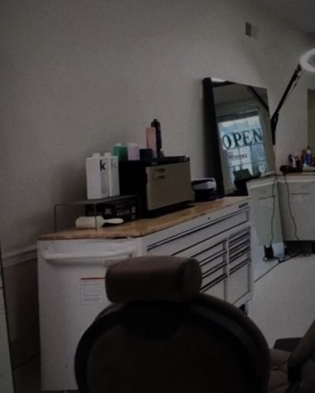 The back of a round barber chair beside a white tool chest
