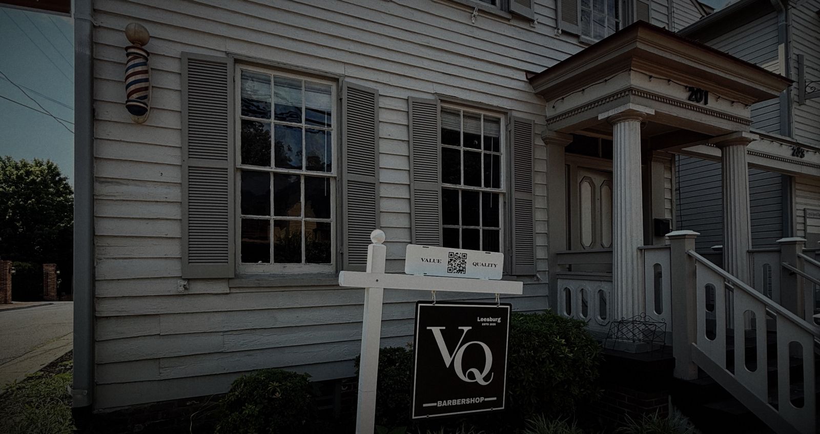 VQ Barbershop at 201 Loudoun St SW: the barber pole on the clapboard front, the VQ sign and the porch steps