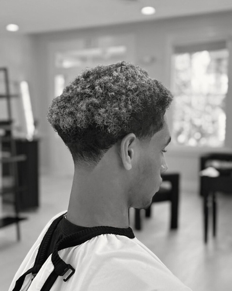 Bleached curly top with a taper