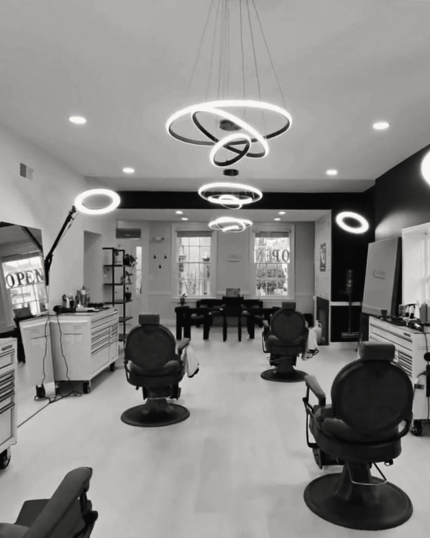 VQ's studio from the back: barber chairs in a row under round ring lights